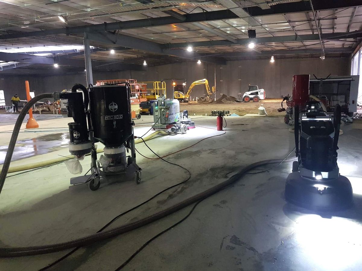 Grinding machines set up across a large commercial floor, the scale that drives cost per square metre