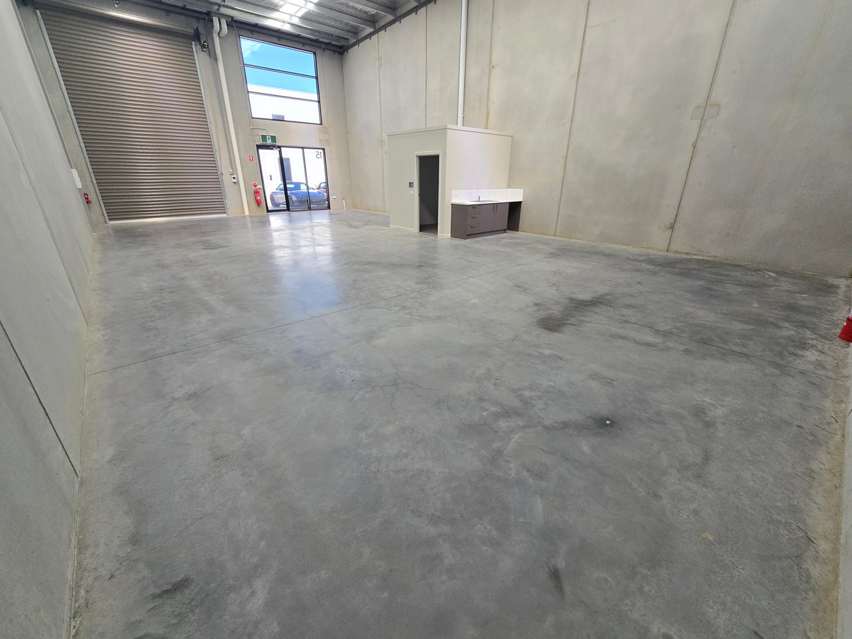 Cleaned factory floor bay with an even, dust-free surface