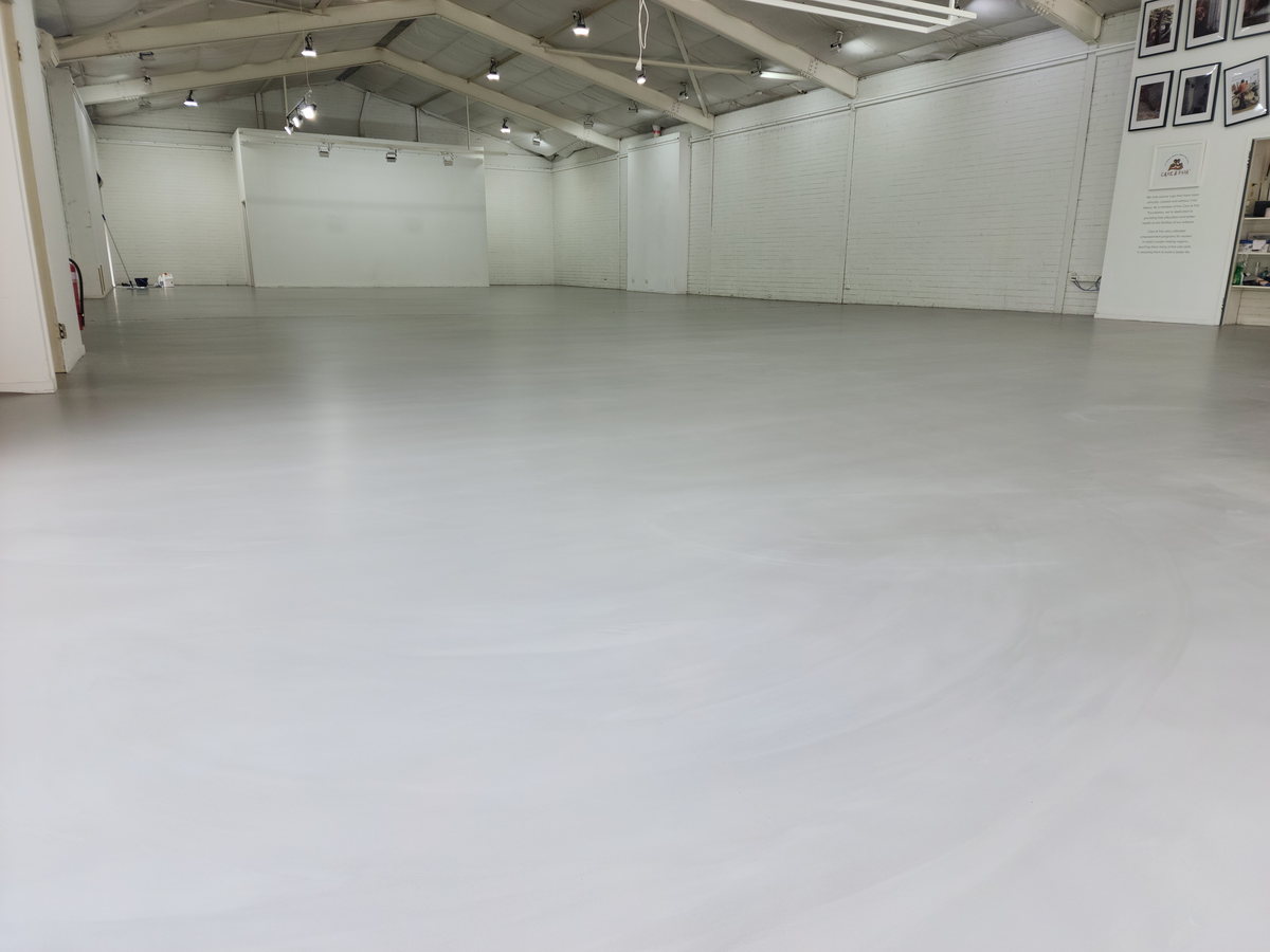 Large hall floor being levelled and prepared across a wide open span