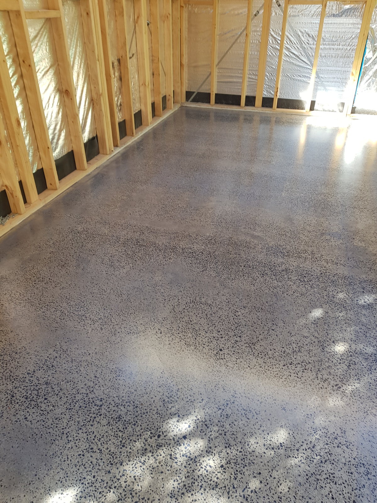 Grind-and-seal concrete garage floor in a timber-framed building