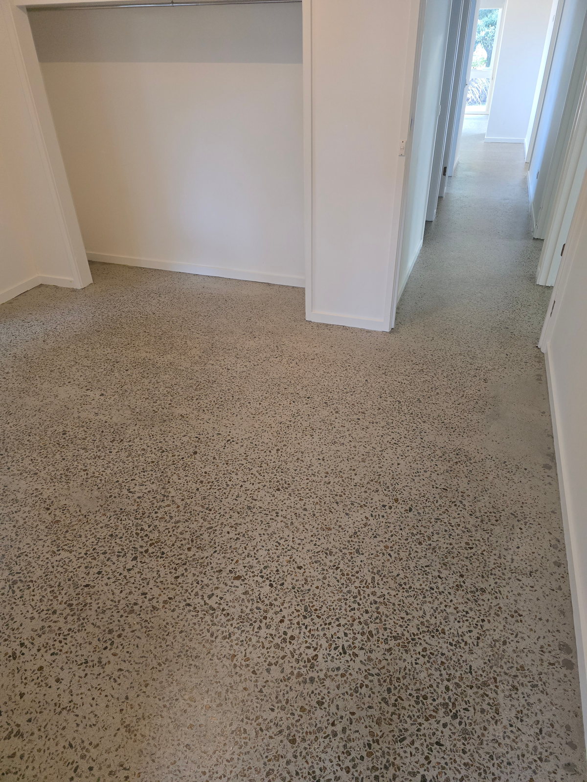 Sealed concrete floor running continuously through a hallway