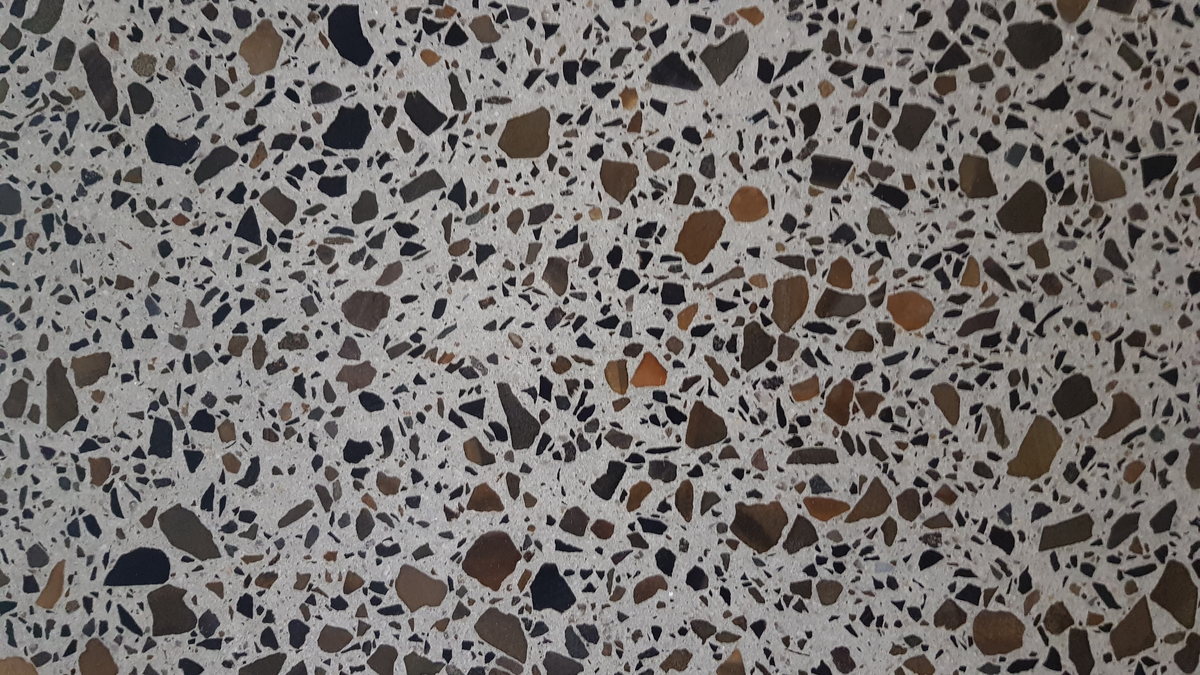 Close view of polished concrete showing dense exposed stone aggregate across the surface