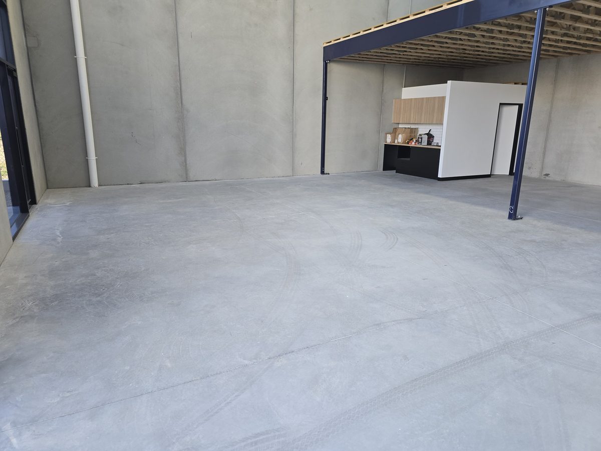 Polished concrete floor running the length of a large warehouse space