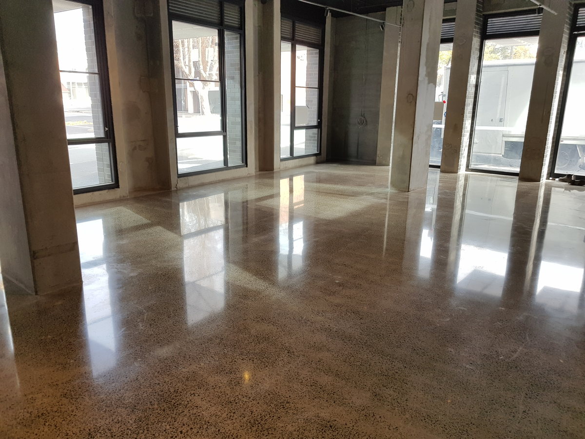 Warm-toned polished concrete floor in a large open interior